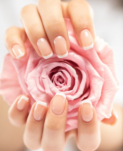 Woman gets manicure procedure in a spa salon. Beautiful female h